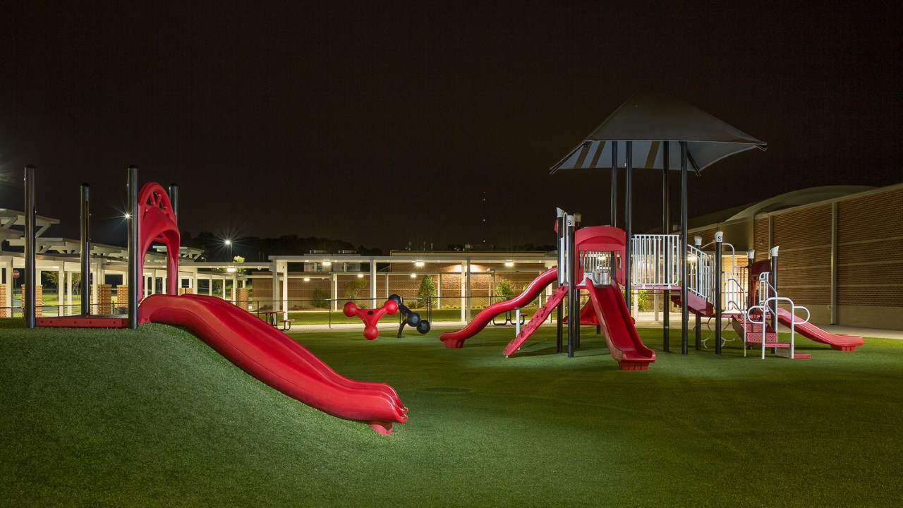 Nighttime artificial turf playground by Southwest Greens